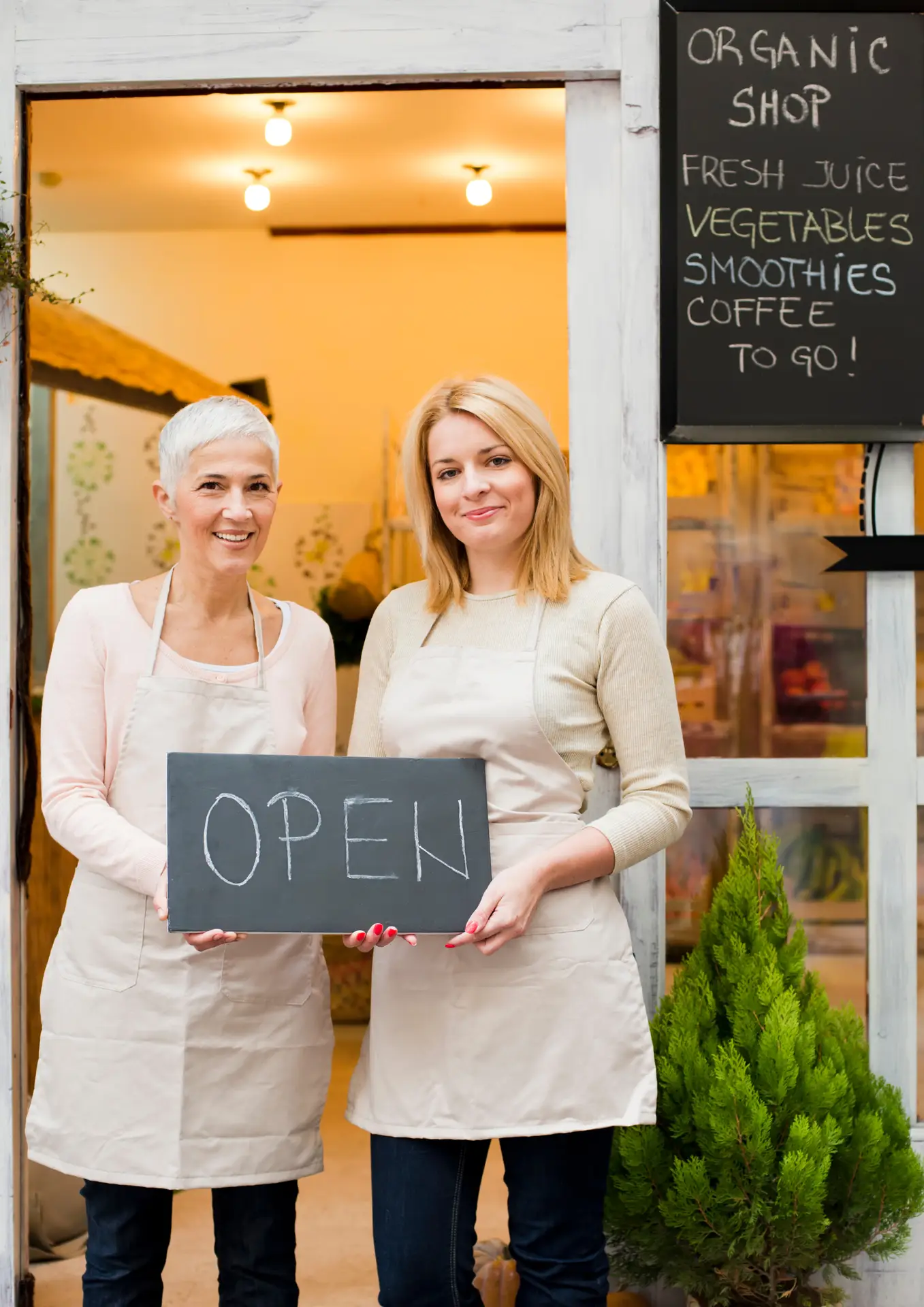 two women holding a sign